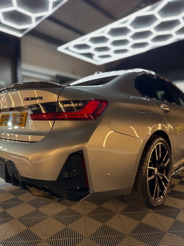 BMW M340i gleaming under the studio lighting after detailing