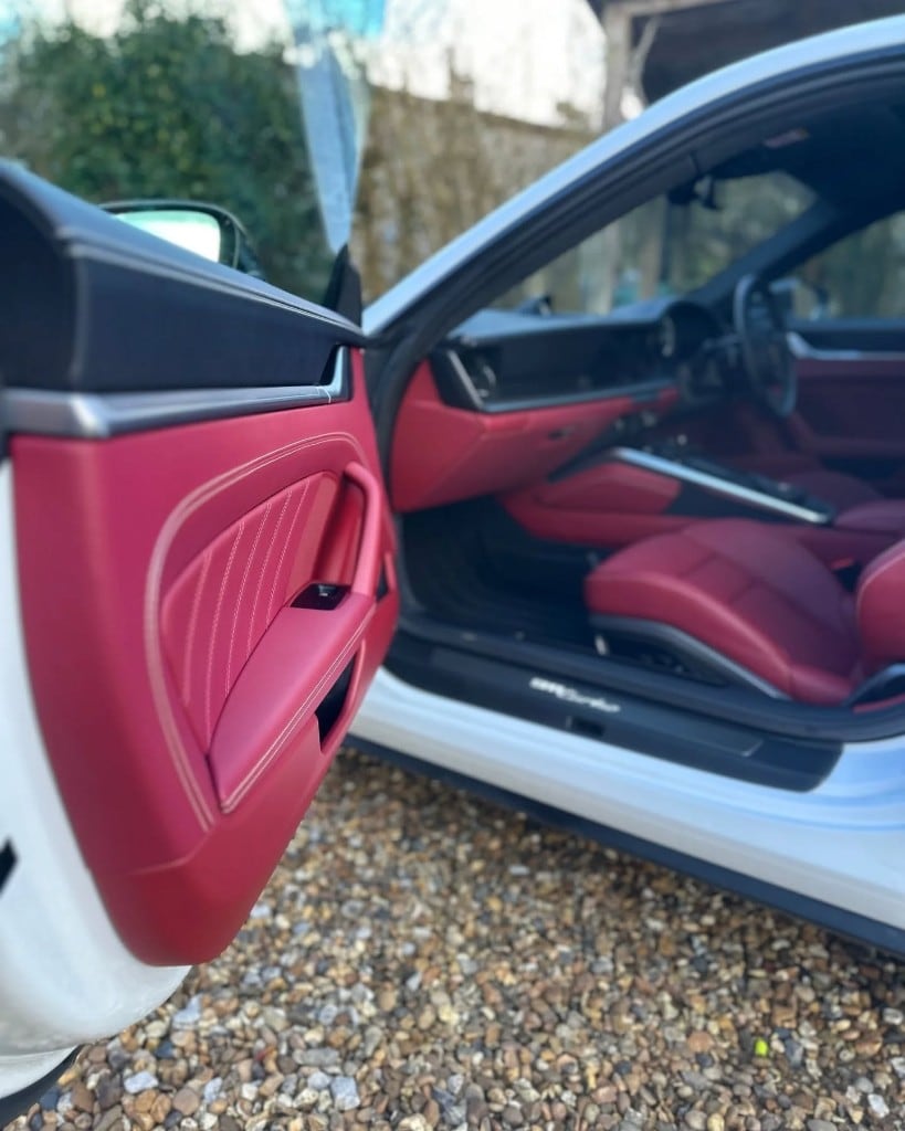 White Porsche 911 with red leather interior detailed