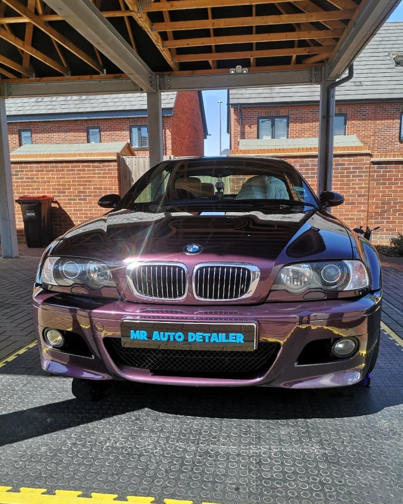 Purple BMW M3 front end gleaming after a full detail