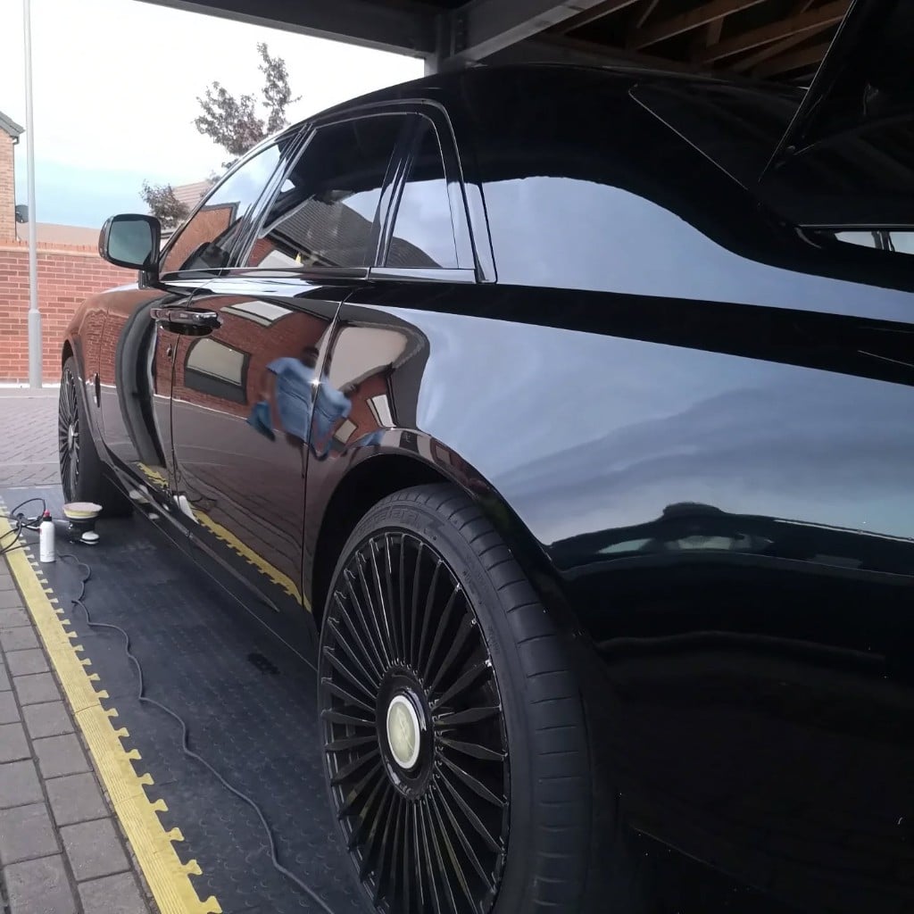 Black Rolls-Royce with a flawless, mirror-gloss finish after detailing