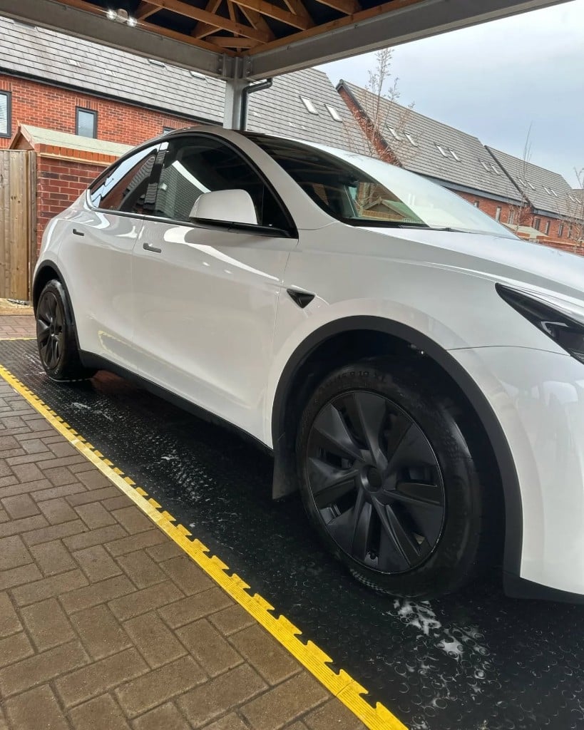 White Tesla Model Y with a spotless, glossy finish after a full valet